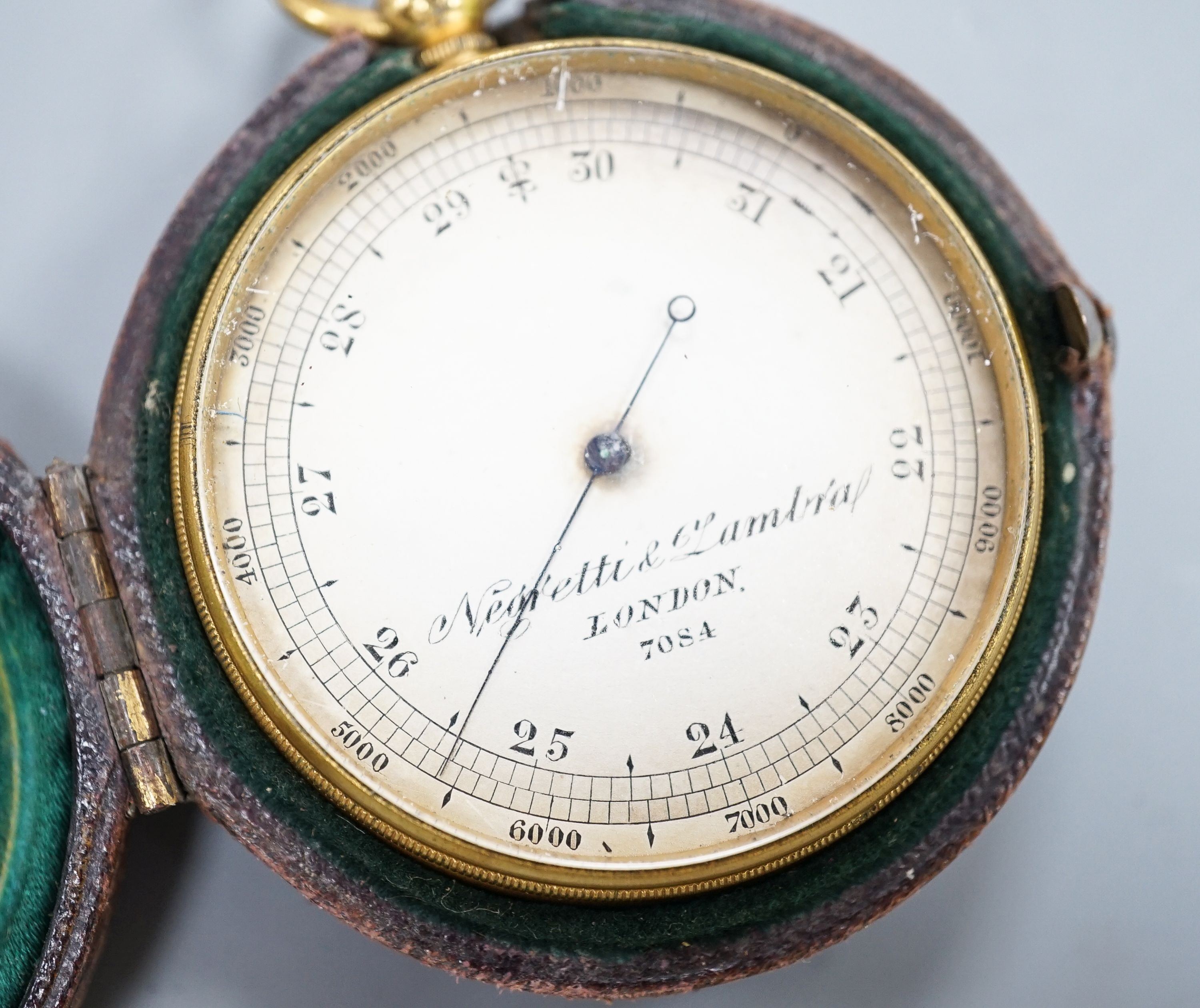 A Negretti and Zambra gilt metal cased pocket barometer